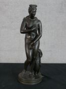 A 20th century cast brass figure of Venus de Medici raised on naturalistic base. H.34 W.11 D.11cm