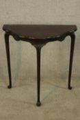 An early 20th century mahogany shaped hall table raised on tapering cabriole supports terminating in