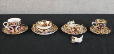 Four Royal Crown Derby Imari porcelain cups and saucers, each with iron red marks to base (one cup