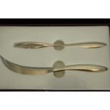 A cased two piece Alain Passard for Christrofle silver plated knife and fork set. L.15 W.25cm.