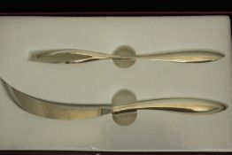 A cased two piece Alain Passard for Christrofle silver plated knife and fork set. L.15 W.25cm.