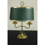 A mid century brass twin branch lamp raised on stepped circular base, complete with green shade. H.