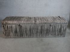 A contemporary gey velvet covered blanket box/ottoman with twin section hinged lid. H.53 W.180 D.