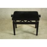A black lacquered adjustable piano stool. H.48cm