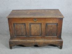 A late 18th/early 19th century oak three panel blanket chest/coffer raised on shaped bracket feet.