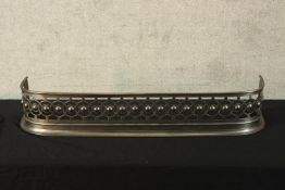 A 19th century brushed steel fender. H.70 W.96cm.