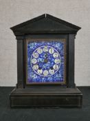 A late 19th century ebonised Architectural mantle clock, the blue and white enamel dial with black