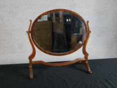 A 19th century mahogany framed oval dressing table mirror raised on trestle style supports. H.49 W.