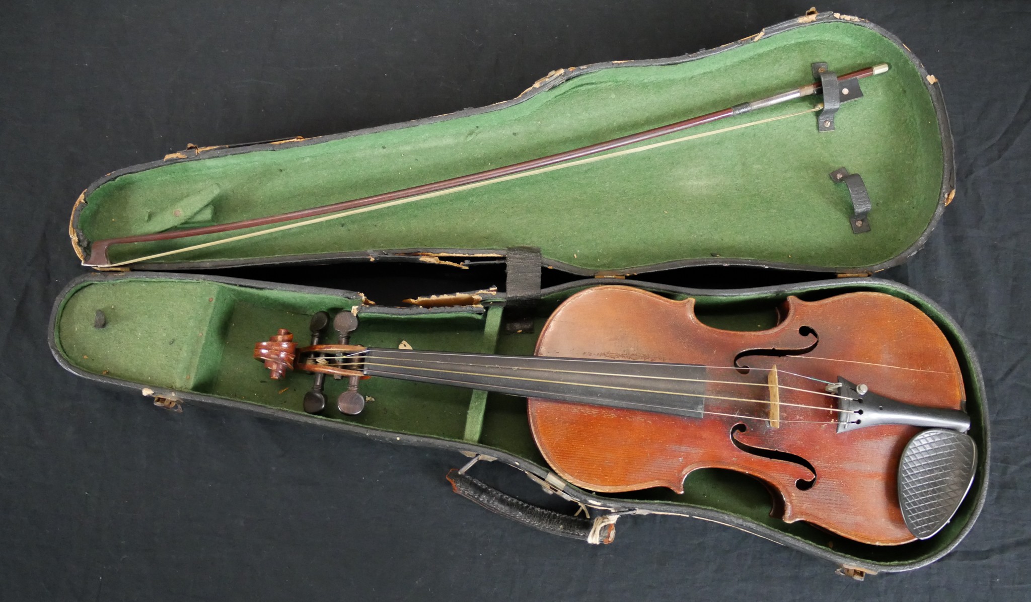A cased late 19th century birds eye maple back full size violin, bearing label complete with bow.