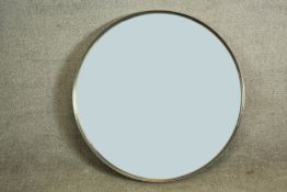 A white metal framed circular wall mirror. Dia.70cm.