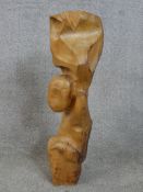 A hand carved tribal style wooden figure. Appears to show a seated figure. 60 (high) x 17 x 17 cm.