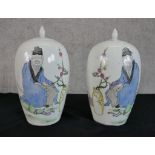 Two Japanese jars, decorated with a portrait of a man next to the branches of a cherry tree and