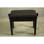 A black lacquered adjustable piano stool. H.48cm.