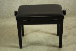 A black lacquered adjustable piano stool. H.48cm.