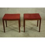 Two stools. Mid century, made from teak and upholstered in red fabric. 46 cm high.