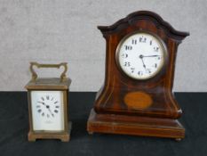 An Edwardian inlaid mahogany mantle clock, the white painted dial with black Arabic numerals
