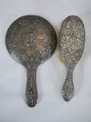 Indian silver plated brush and mirror. With embossed decorative handles and frame. H.27 x W.15cm