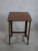 A 20th century pine folding sloping school desk raised on square supports. H.81 W.56 D.52cm
