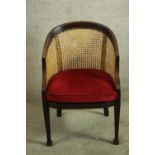 An Edwardian mahogany framed beregere bow back tub chair.