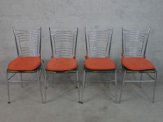 A set of four vintage chrome plated ladder back and vinyl seated bistro chairs raised on tapering
