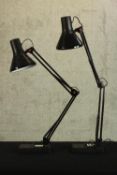 A pair of contemporary black Anglepoise desk lamps, each raised on rectangular bases. H.84cm. (each)