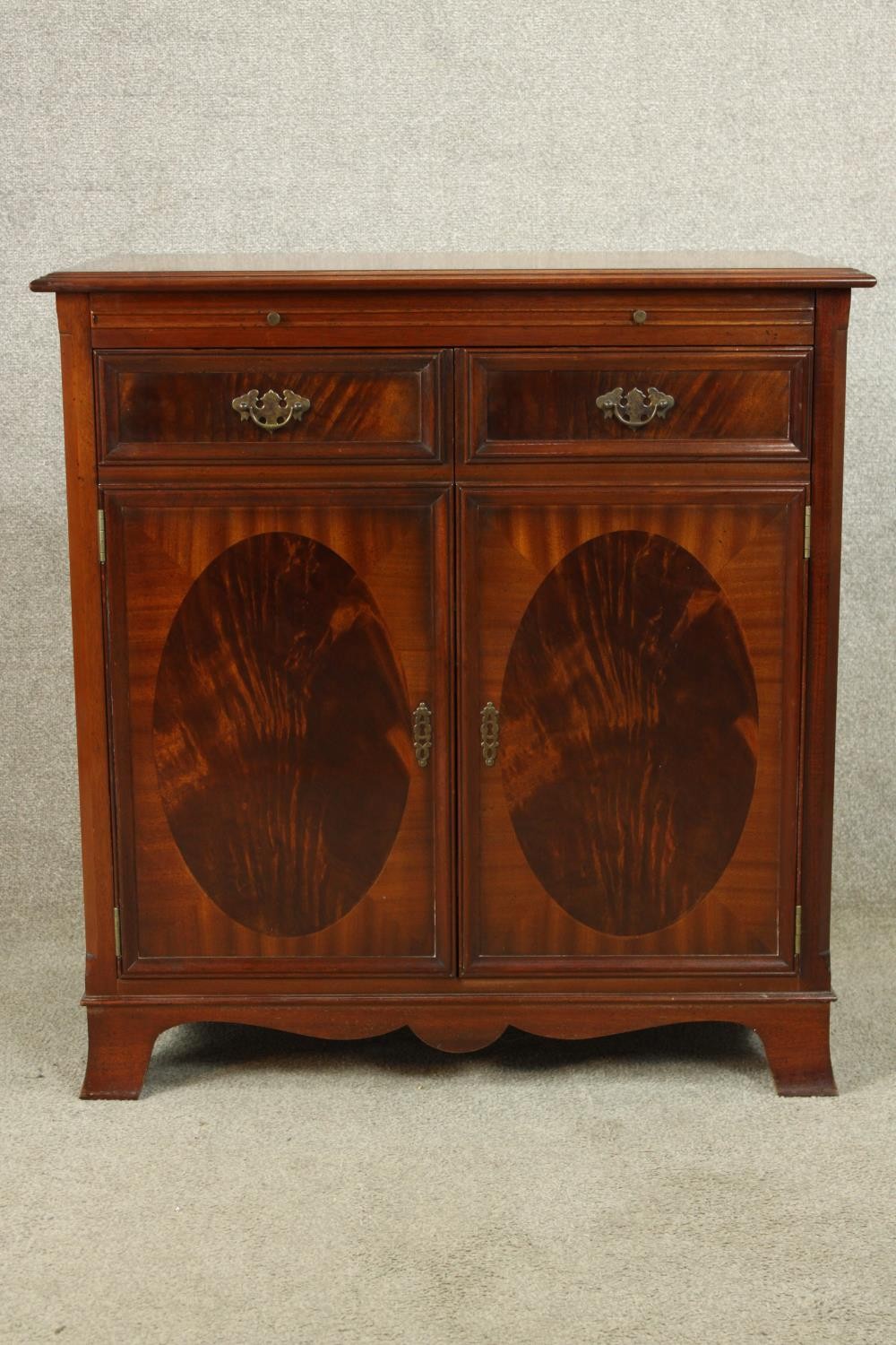 A contemporary Regency style twin door entertainment cabinet complete with with turntable, amp,