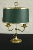 A mid century brass twin branch lamp raised on stepped circular base, complete with green shade. H.