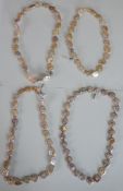 Four freshwater blister pearl necklaces with secure white metal clasps. H.30cm