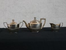A sterling silver teaset, viz: Teapot, creamer and sugar bowl, each hallmarked with a lion, anchor