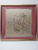 A framed and glazed silk embroidered cushion cover. H.66.5 W.66.5 cm