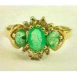 A 9ct gold emerald and diamond three stone cluster ring. Hallmarked: G&TJ, 375.