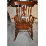 A Windsor style rocking chair. H.117 cm.