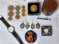 A collection of medals and coins, including four silver shield medal fobs and a silver and enamel dr