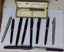 A collection of fountain pens, mostly with gold nibs.