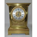 An early 20th century brass mantle clock with relief scrolling foliate and knight design, classical