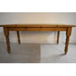 A rectangular pine farmhouse style kitchen table raised on turned supports. H.77 W.183 D.92cm