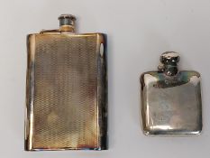 Two lockable silver hip flasks, one with an engine turned design ands the other square. H.15.6 W.10