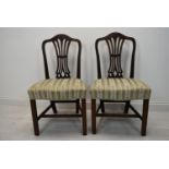 A pair of Hepplewhite style mahogany dining chairs.