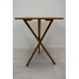 A vintage cross legged table. H.78 W.53 D.46 cm.