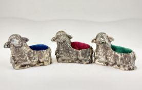 Three Danish novelty silver pin cushions in the form of lambs.