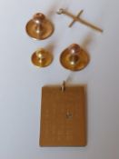 Four gold shirt stud backs, a 9ct gold pendant in the form of a calendar with a diamond set on one d