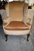 A Mahogany Georgian style wingback armchair. H.112 cm.