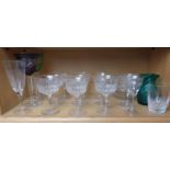 A collection of glasses, including two Bohemian cut to clear wine glasses in purple and green.