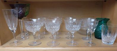 A collection of glasses, including two Bohemian cut to clear wine glasses in purple and green.