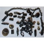 A collection of jet and black glass mourning jewellery, including a carved jet chain link necklace,