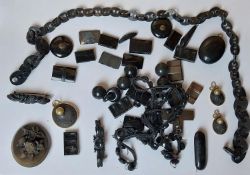 A collection of jet and black glass mourning jewellery, including a carved jet chain link necklace,