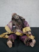A late nineteenth century Indian puppet in traditional dress. With a horse hair beard delicately