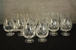 A mixed collection of cut crystal brandy and wine glasses. Twelve glasses in total, six for brandy