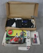 A mid 20th century boxed Scalextric Postril car racing set complete with instruction manual.W.100