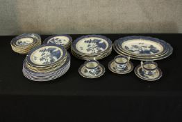A mixed collection of Willow gilt rimmed porcelain. To include three cups and saucers and an